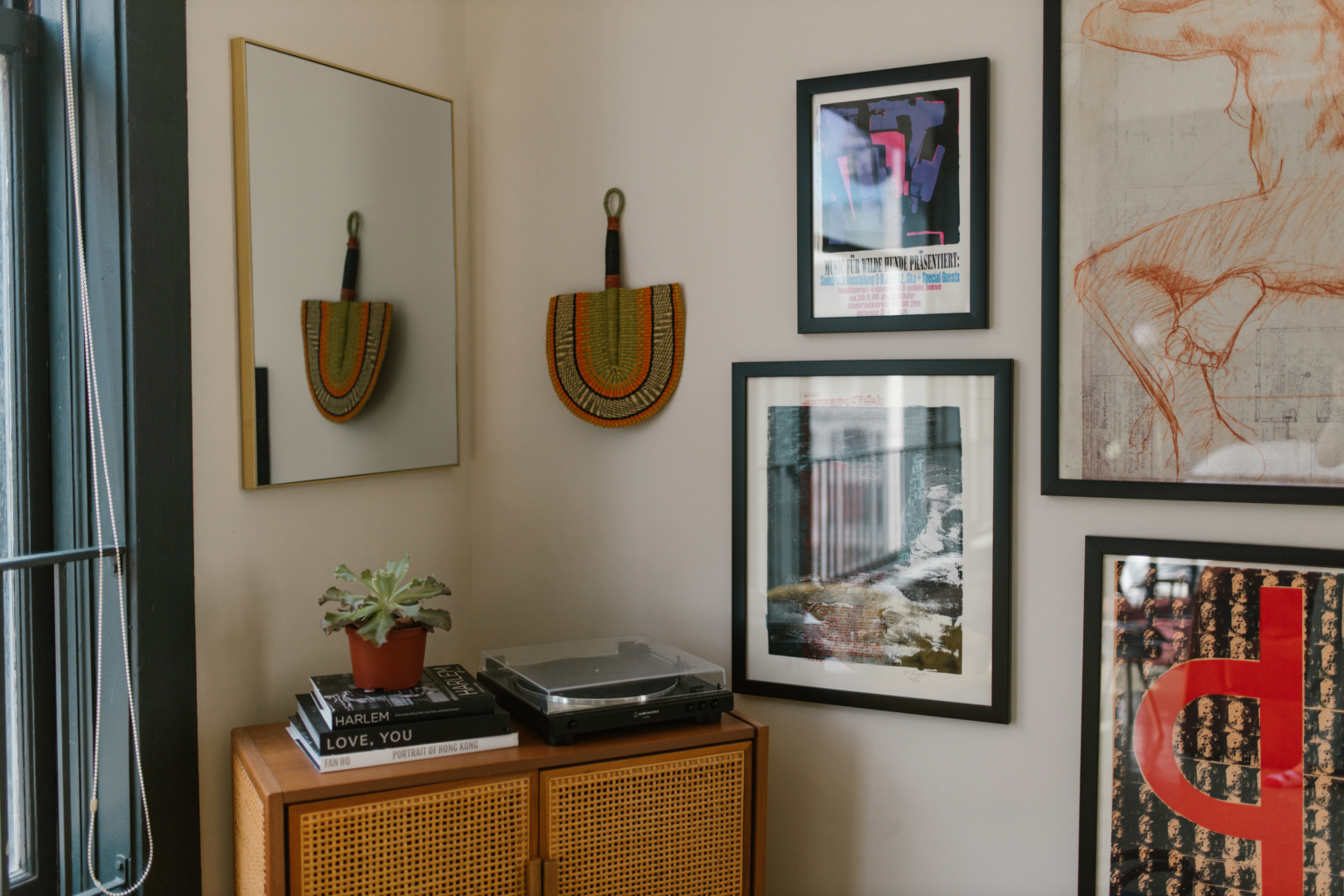 Image of home with vintage art and wall art. Looks like a culture home clean and minamilst